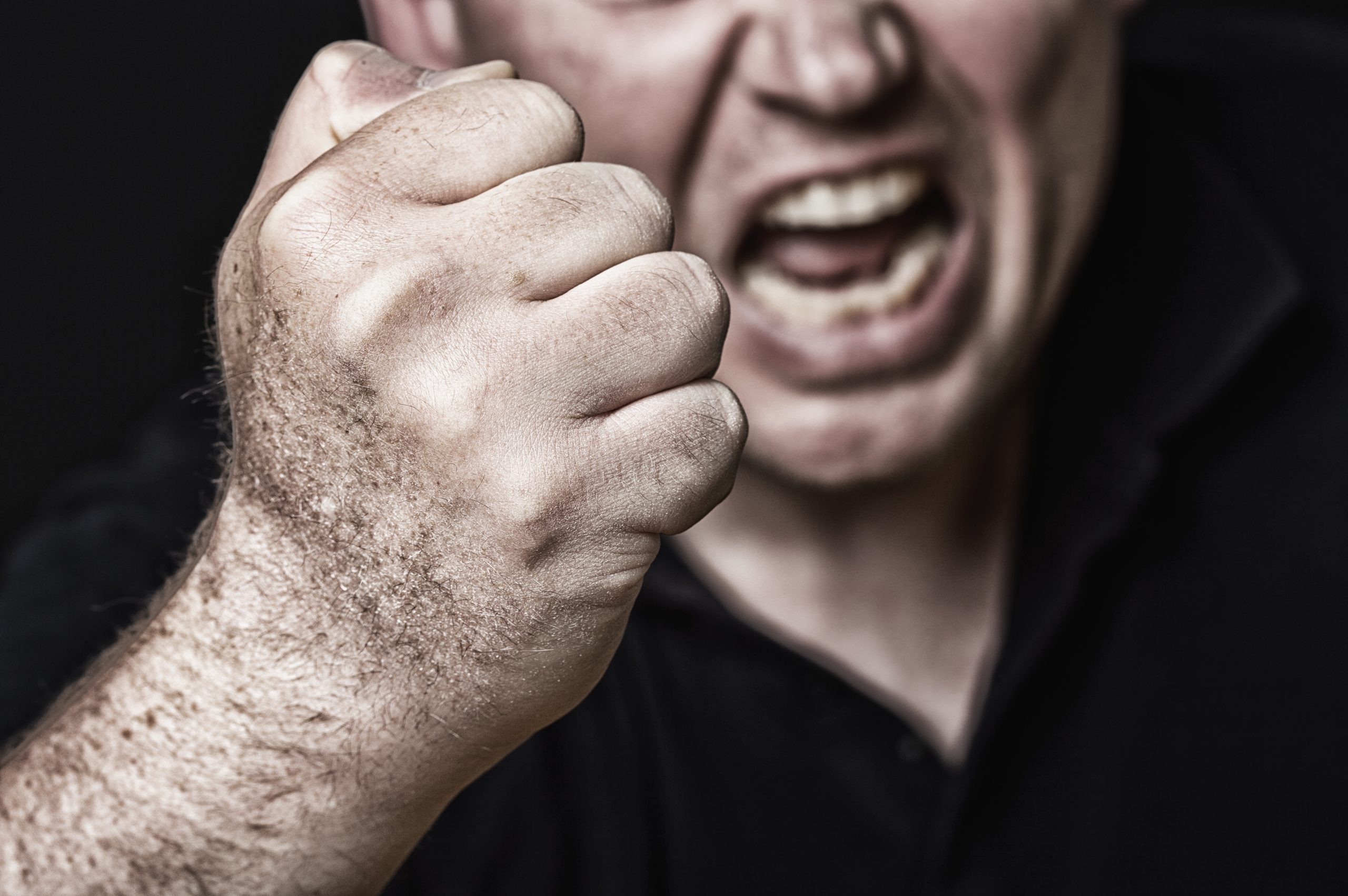 man threatening with fist